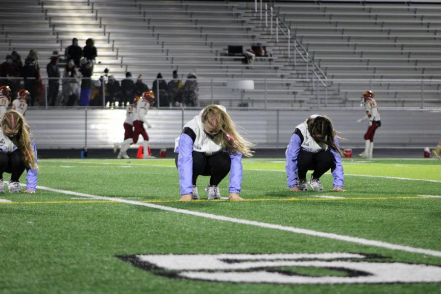 Junior Nora Wickless, Sophomore Emma Wambsgans, and Freshman Ava Enicke performing at halftime. 