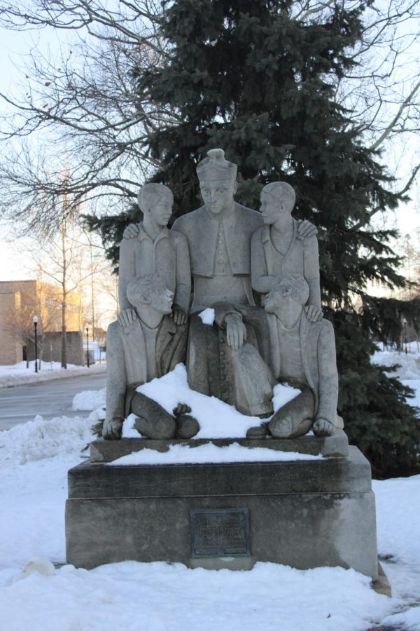 Statue in Boystown of the founder and children around him