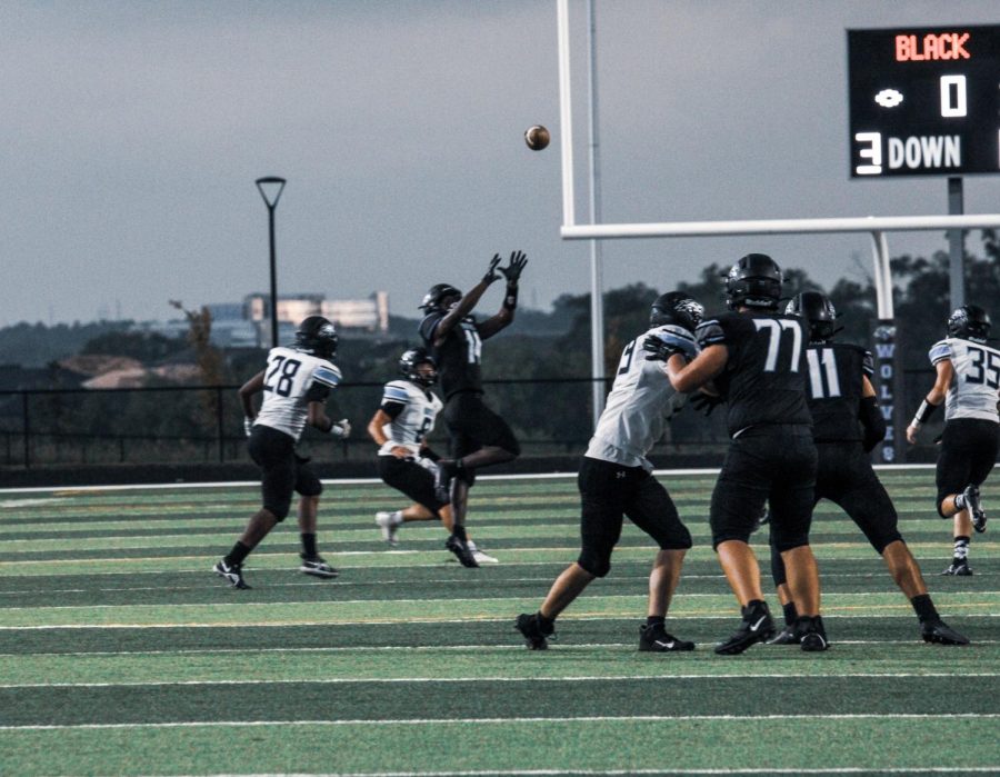 Kyree Bennett in the air trying to catch the ball.