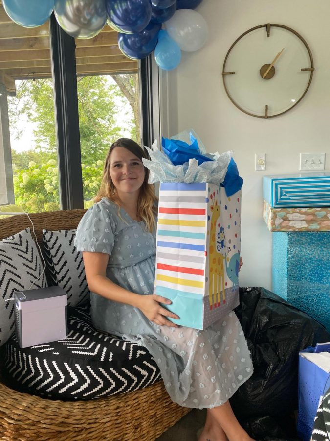 Chloe Healy holding a present at her baby shower