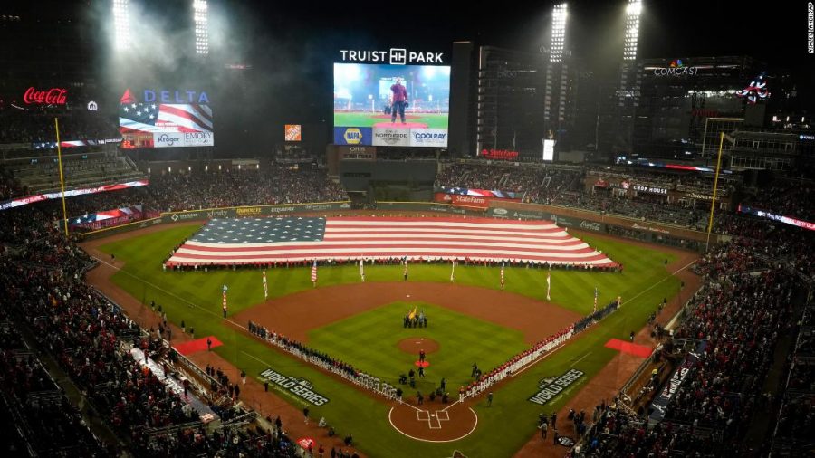 A flag covers outfield during the national anthem before Game 3 of the World Series 
