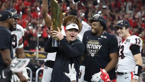 Kirby Smart holding his National Championship Trophy