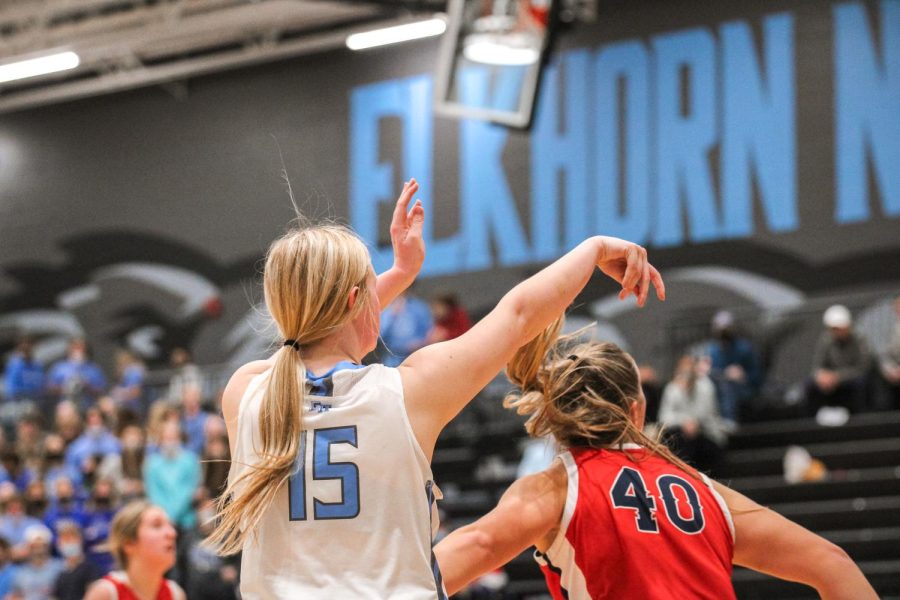 Hannah Nadgwick attempting to shoot a corner shot as Norris watches anxiously. 