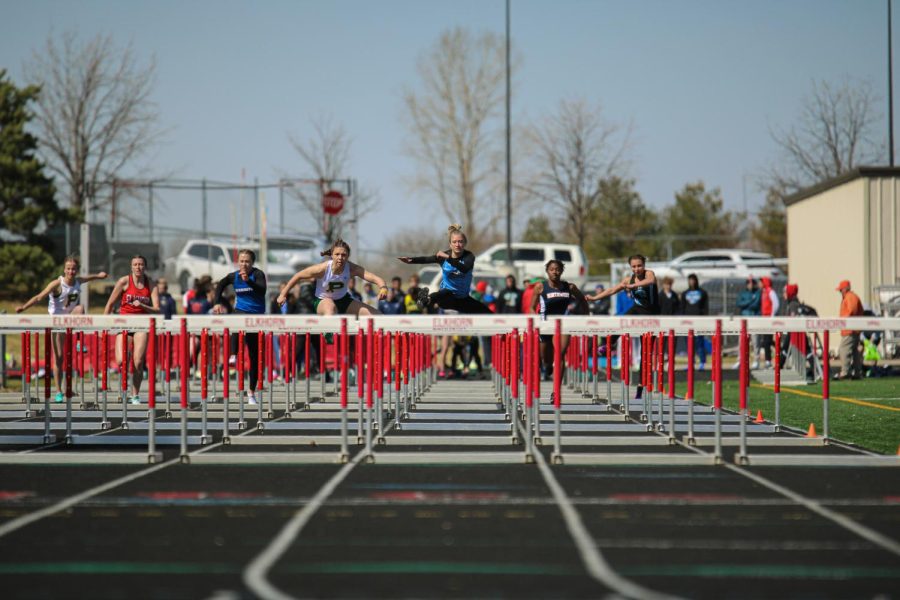Savannah Bishop jumps midair as she runs preliminary round of the 100m hurdles. Bishop qualified for the 100m finals. 