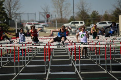 Horner jumps over the hurdle in the 110m hurdles. Horner places second in the preliminary round of the 110m hurdles and qualified for the finals. 