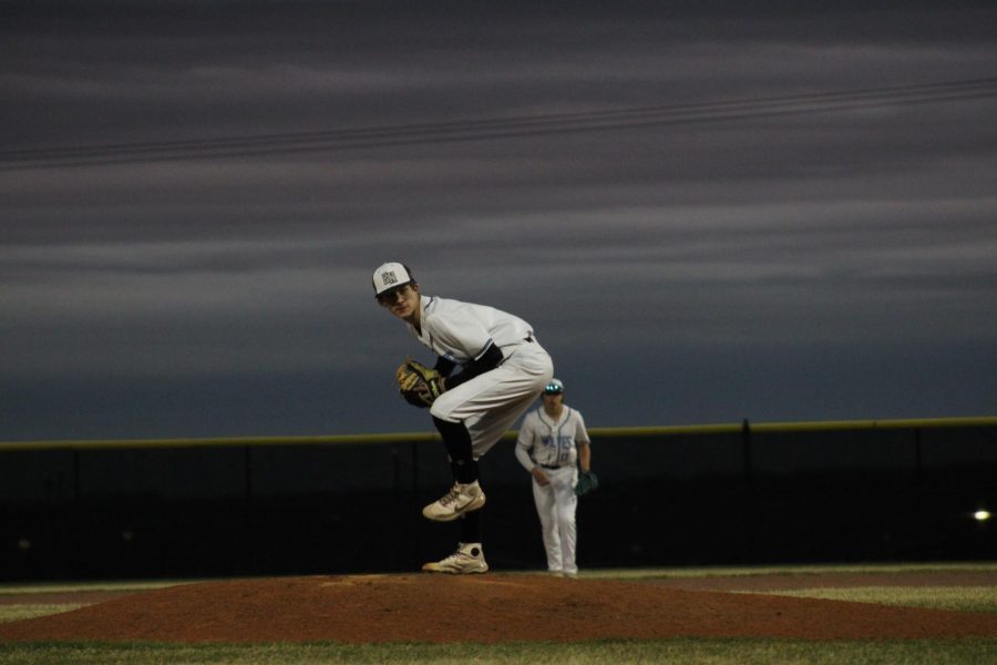 Pitcher, Cole Fischer, mid-delivery on the mound. Fischer relieved Owen Hess and led the Wolves to an 11-10 win.