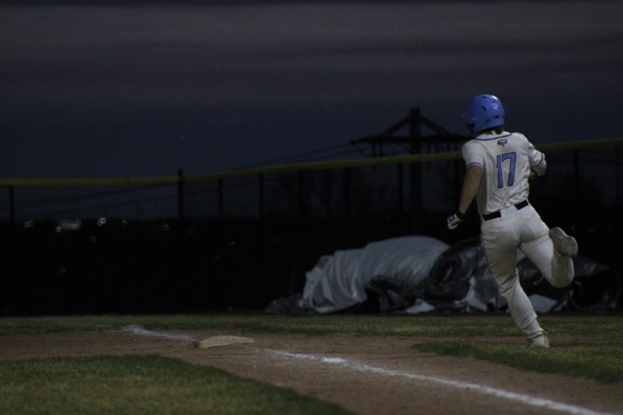 Tyson Fancher rounding first after his pop-fly died in front of the right-fielder. Fancher has been swinging between Varsity and J.V. this season, and has made many contributions to both. 