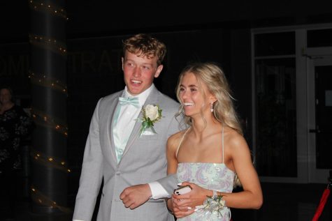 Jacob Horner and Jade Noonan lock arms as they walk into prom.