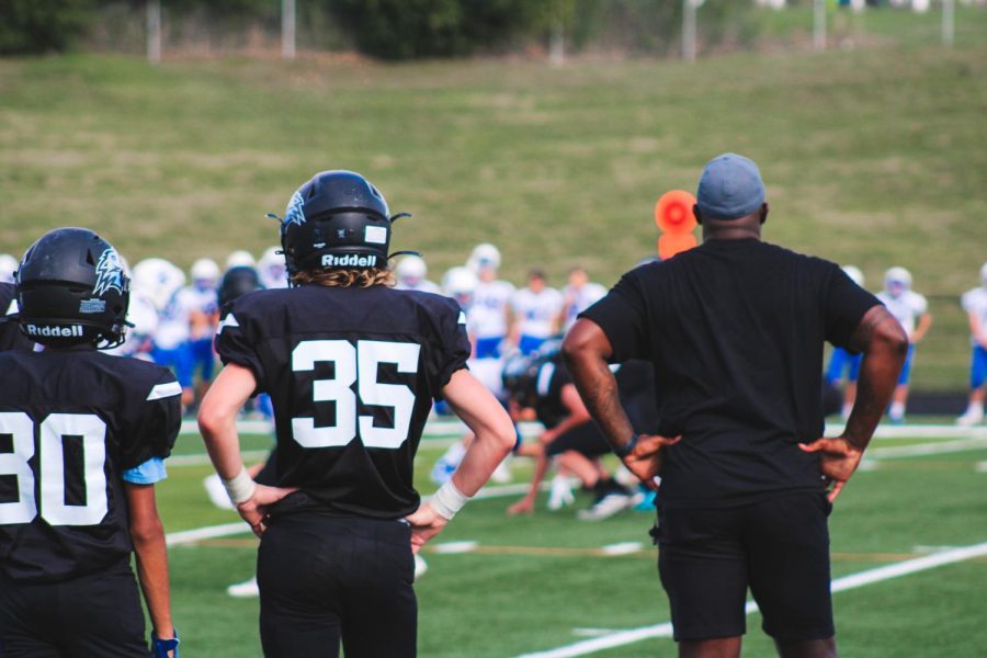 #35, Ben Hanson, and Coach _____ power posing on the sidelines. All players were attentive and cheered for their teammates success the entire game.