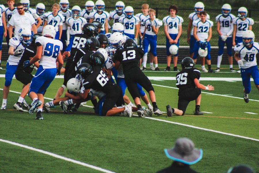 #13, Ethan Asmus, making a tackle against the opposing quarterback. Asmus has been playing Defensive end for Elkhorn North.