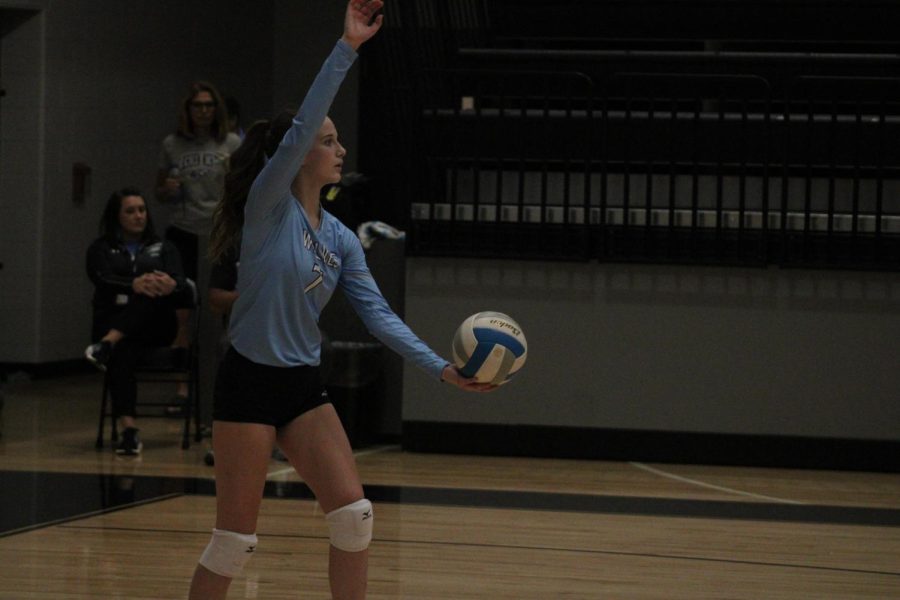 Freshman outside hitter, Ava Thompson, serves the ball at the start of the first set.  The Wolves win the point in order to give them an early first set lead.  