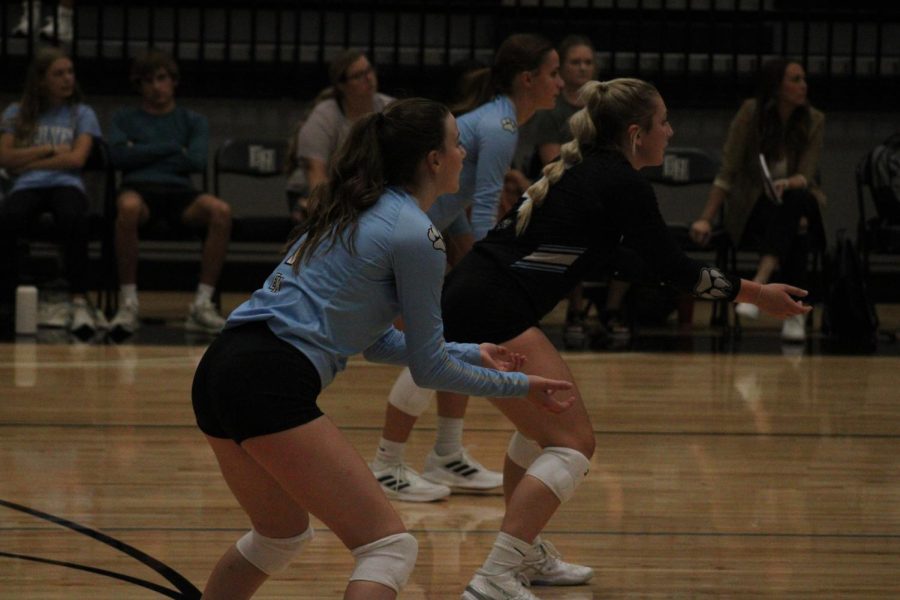 Thompson on the right,  in the middle junior libero Anna Martin, and on the far left outside hitter Savanah Grabenstein waits in serve receive as the other team serves the ball.  The Wolves are looking for a perfect pass to the setter in order to win the point.   