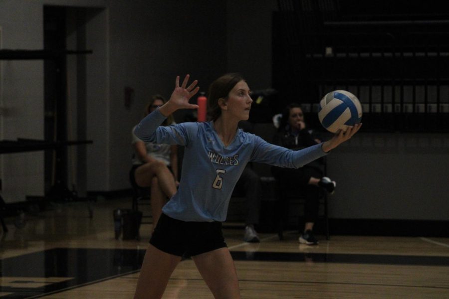 Freshman setter Hayden Booth serves the ball at the end of the first set.  The team is looking to keep their lead against Waverly.     