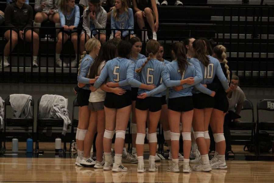 The JV girls volleyball team huddles before the game against Waverly on Thursday September 8th.  The JV team was looking for another win in order to keep their regular season undefeated record. 