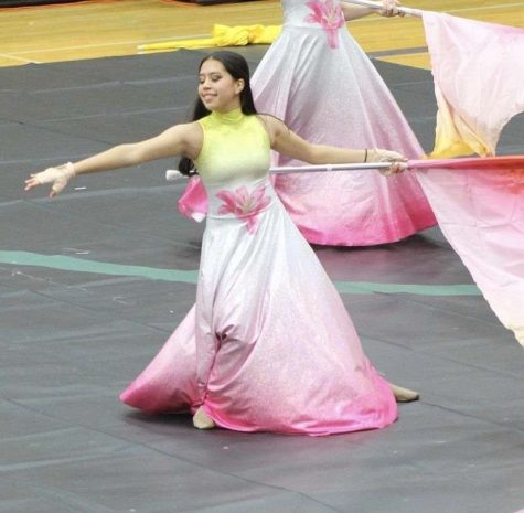 Amanda Hoffman waving her flag at a winter guard competition.