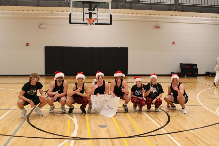 Dodgeball+team%2C+Christmas+Came+Early%2C+poses+with+the+bracket+right+after+winning+the+championship.+
