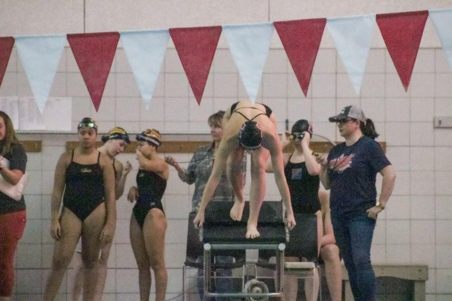 Junior Shea Knudsen gets set before her before her 200 Yard Freestyle.  Knudsen swam a time of 2:21.09 and placed 5th in her event.  
