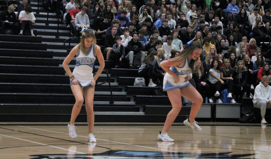 Ava Raridon (left) and Loghan Evert (right) dance together during the dance team performance. They smile and have fun while dancing during the pep rally.