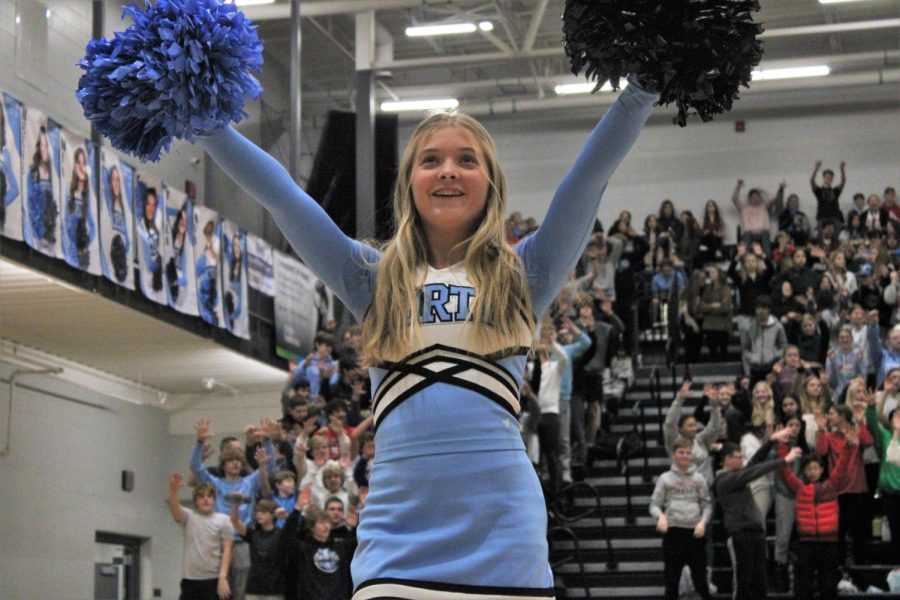 Junior Colby Driever cheers excitedly during the pep rally. Driever smiles proudly while performing the beginning cheer.
