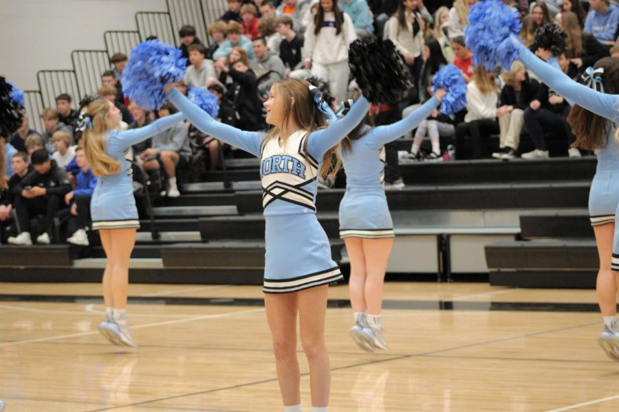 Ellie Bailey cheers with the other girls during the beginning of the pep rally. They jump in the air while waving their pompoms.