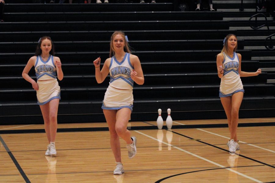 Alie Dixon (left), Sophia Bandfield (center), and  Ava Raridon (right) dancing at the pep rally. All three dancers are swaying their arms.