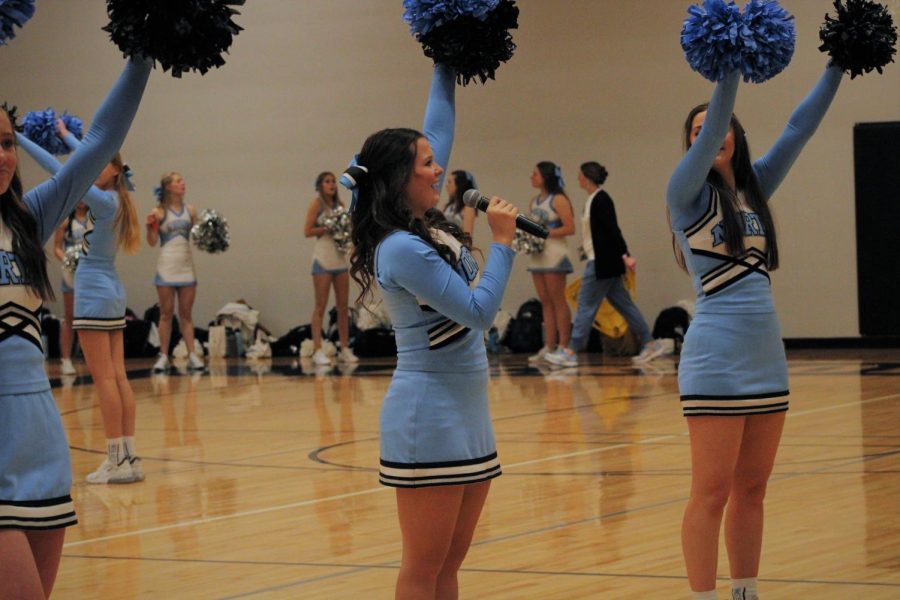 Senior cheerleader Reese Aliano leads the cheers at the pep rally. Aliano teaches the underclassmen how to do the “Paws Up” cheer.