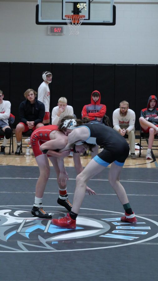 Senior Carter Reichenberg gets a firm hold in his match to help beat his opponent.