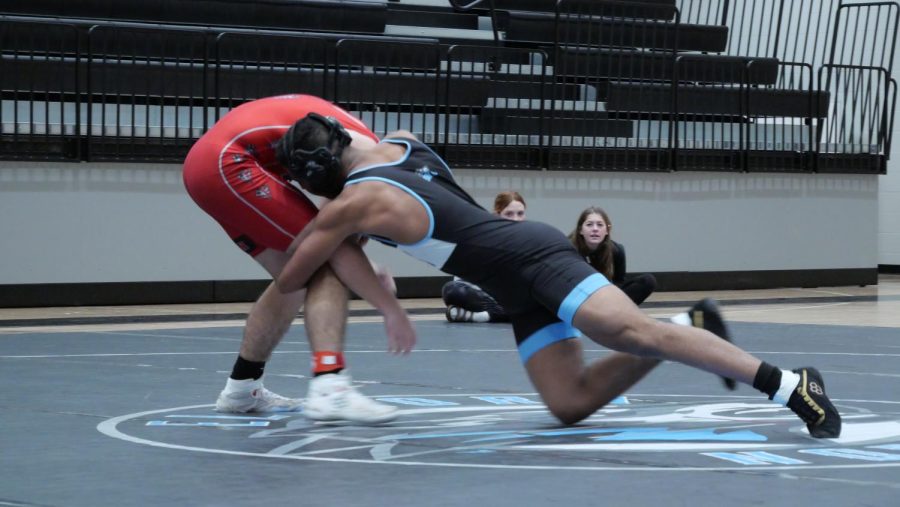 Senior Trey McDougald reaches for his opponents leg as he goes for the takedown. The Wolves take a 49-27 victory over Yutan.