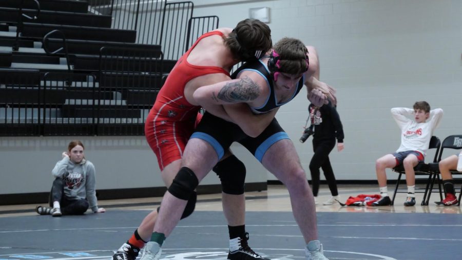 Cole Ovens, junior, prepares to take down his opponent for a clean finish.