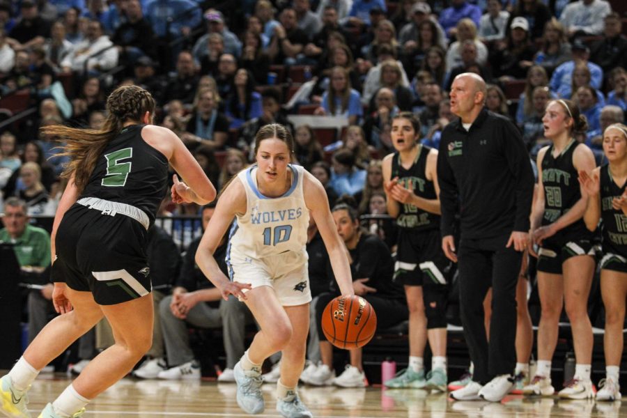 Senior Grace Thompson advances towards the hoop with approaching Skutt defenders.  