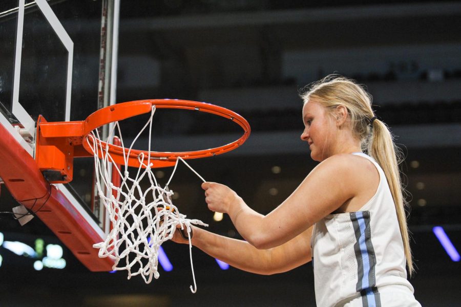 Hannah Nadgwick cuts the net at Pinnacle Bank Arena after winning the Class B State Championships.