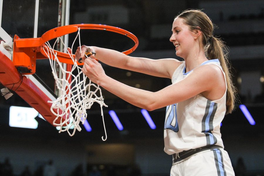 Grace Thompson cuts the net at Pinnacle Bank Arena after winning the Class B State Championships.