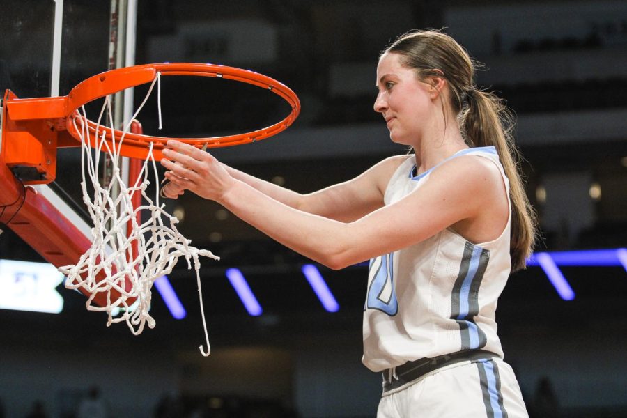 Grace Thompson cuts the net at Pinnacle Bank Arena after winning the Class B State Championships.