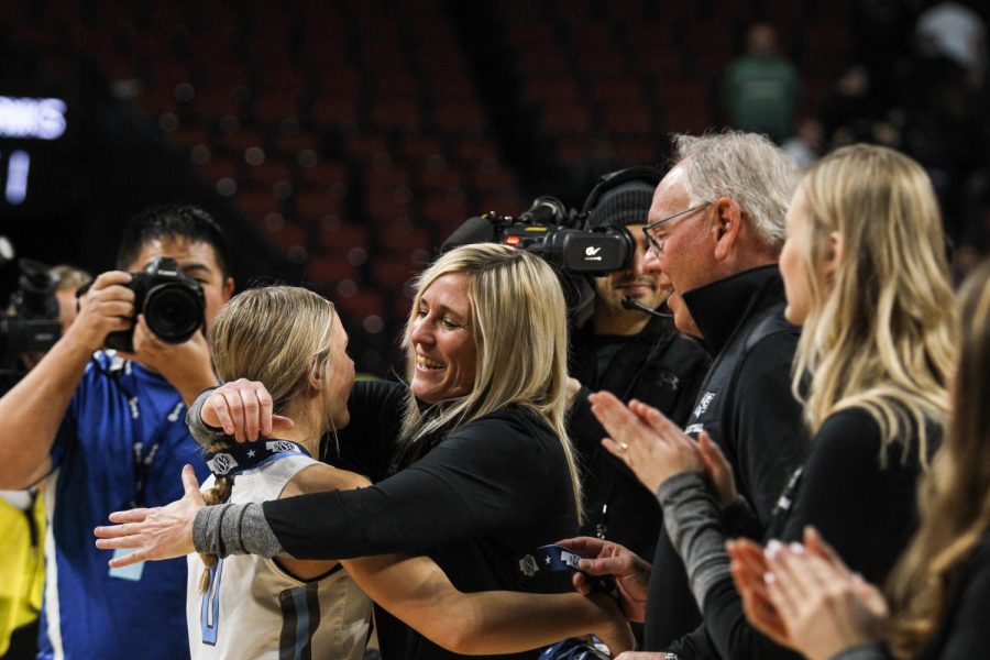 Halle Pribnow hugging head coach Anne prince after receiving medal for state. Wolves won the state championship game for the 3rd year in a row. 