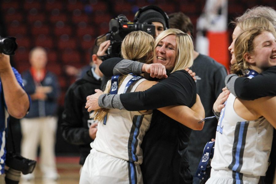 Britt Prince hugging her mom, head coach Ann Prince, after receiving medal for state. Wolves won the state championship game for the 3rd year in a row. 