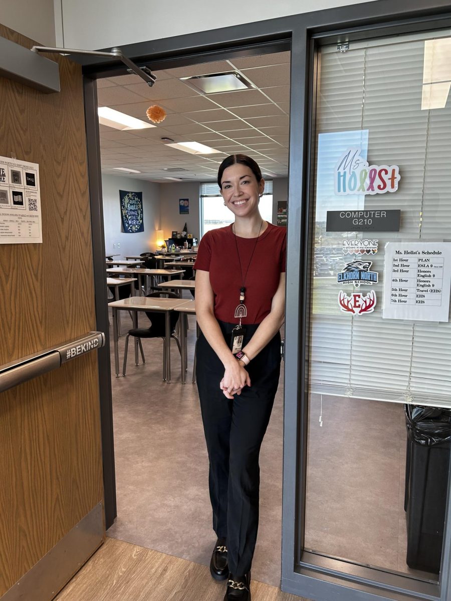 Ms. Hollst standing in fron of her classroom on September 26. She was excited to display some decor in her room.