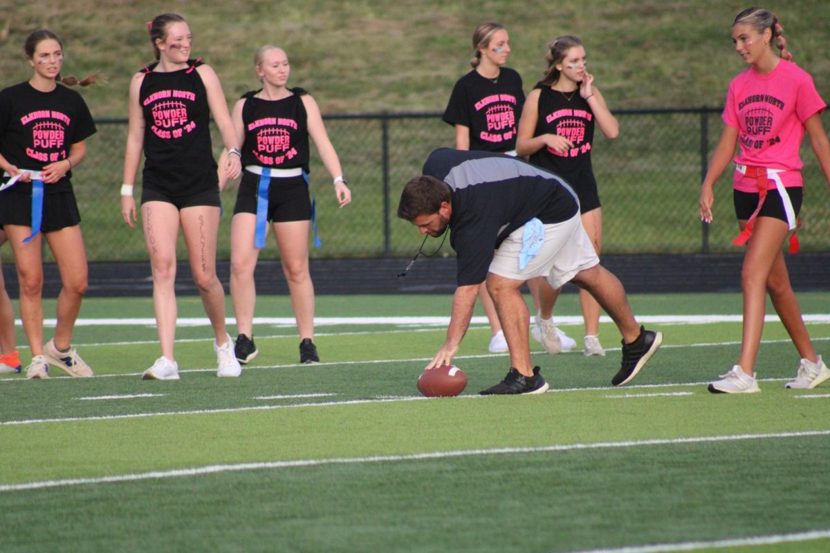 Referee Anthony Dunn sets the football for the next play on September 13, 2023. He is the varsity baseball coach for Elkhorn North Highschool. 