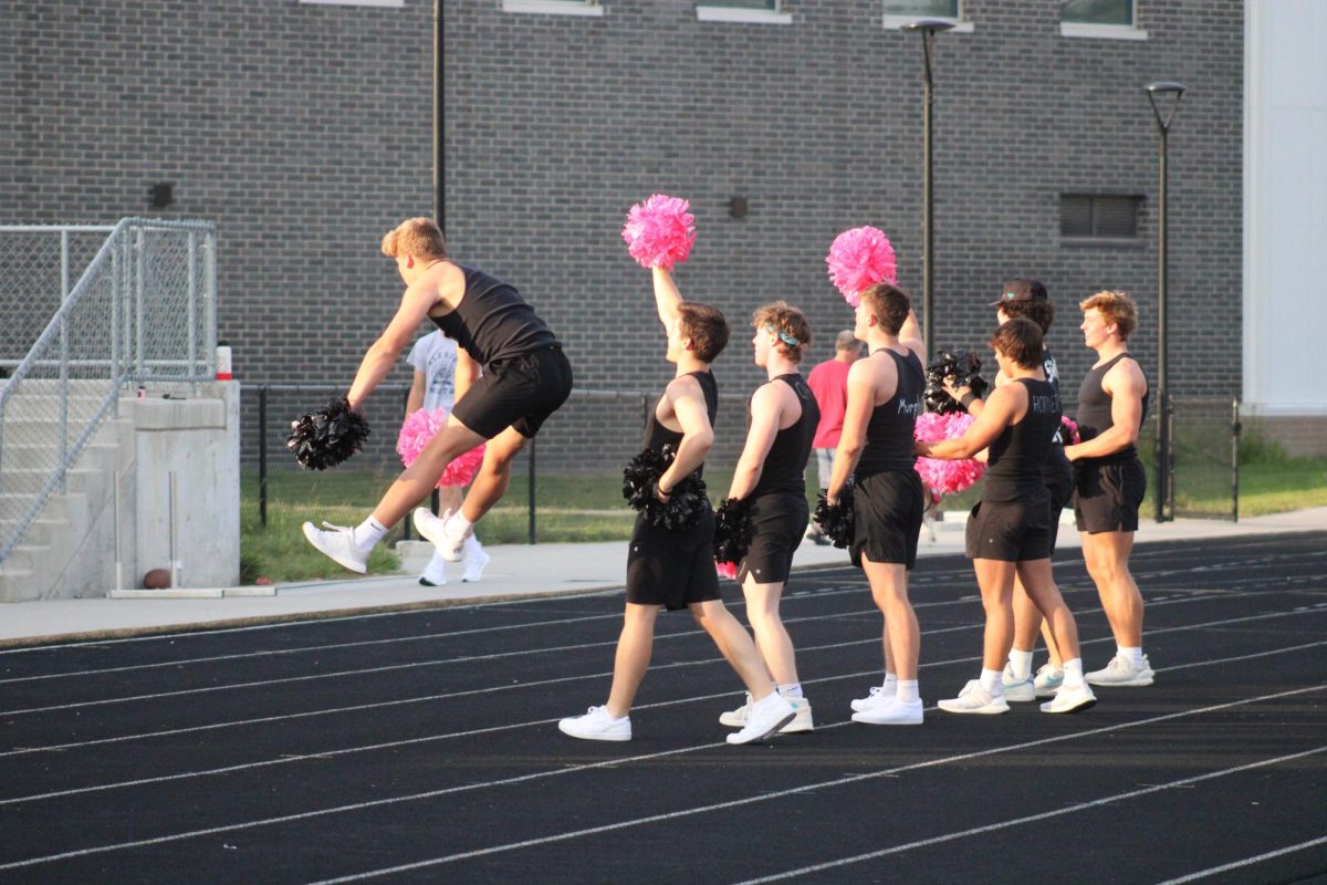 Senior Jayse Munter attempts to do a toe touch on the sidelines during powder puff night on September 13, 2023. He is involved with the musical and choir at Elkhorn North Highschool.