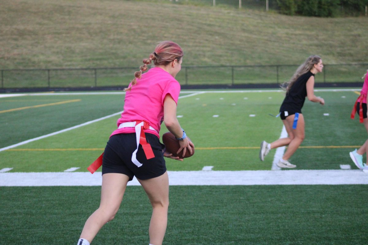 Sydney Stodden is carrying the ball on the field for the next play in powder puff on September 13, 2023. She plays on varsity basketball and track. 