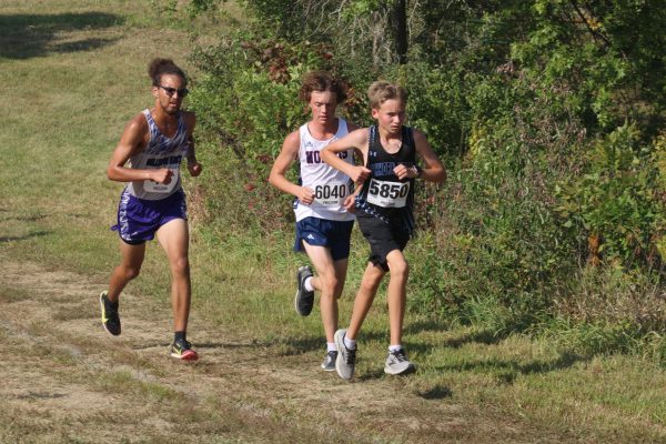 Noah Lange passes a competitor in the boys JV Cross country meet at Mount Michael.  Lange is a sophomore and this is his first year running cross country. 