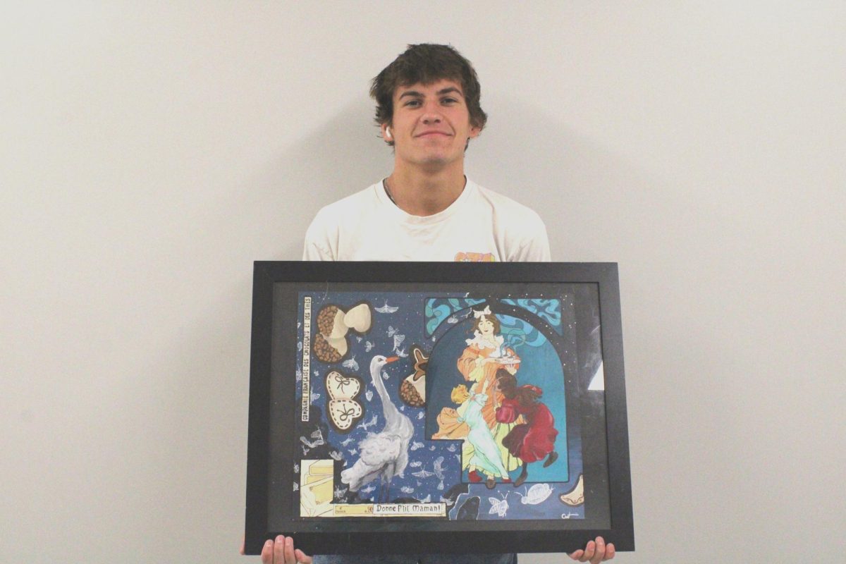 Caden Wieseman stands with his acrylic painting collage. Creative techniques is the senior art class where students put together their portfolios.