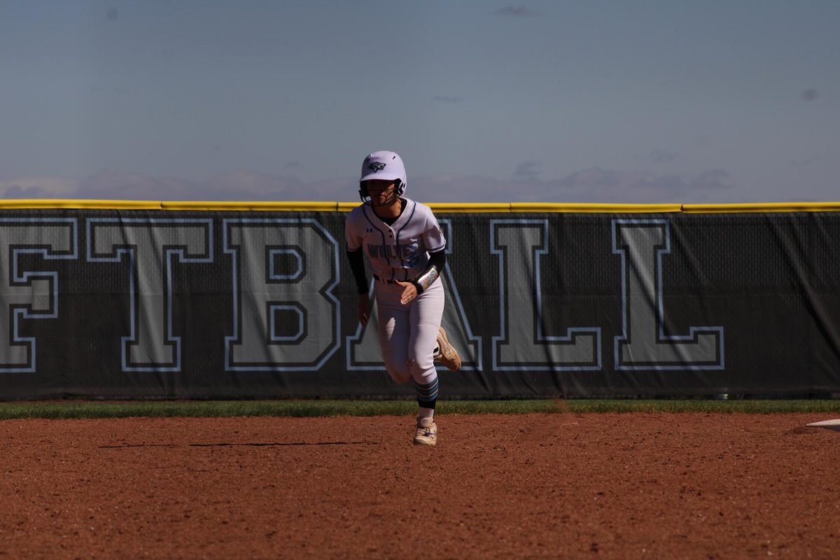 Lilly Loghry running to third base on. Loghry is a senior and runner on varsity softball. 