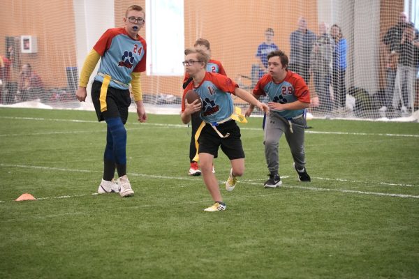 The Top Dogs, a unified sports team, competes in the Flag Football Special Olympics on October 14. They pulled away with the touchdown. Photo courtesy of Renee Vokt 