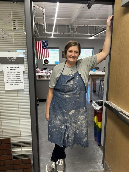 Lucks standing in front of her Ceramics and Art classroom. Her room is located in G009.