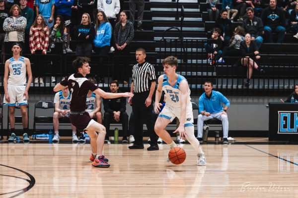 Junior Will Farrington dribbles the ball up the floor, starting the offensive set for the wolves. This was at the game on Dec. 16, 2022 vs Waverly which resulted in a loss of 62-40.