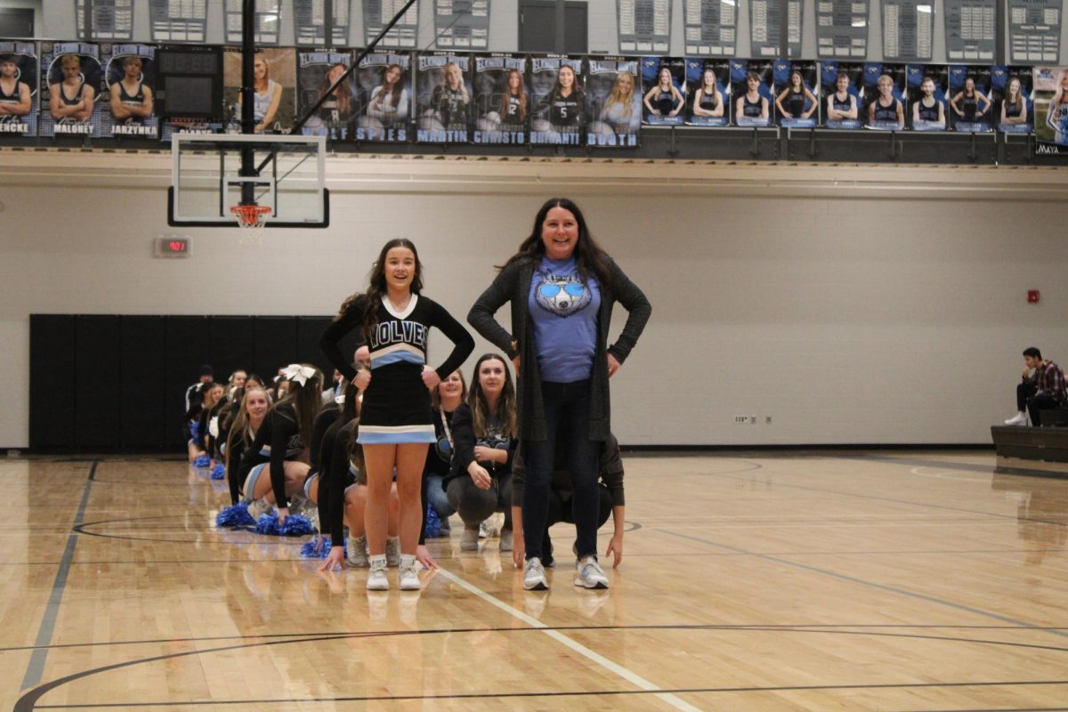 Cheer coach Reyne Armbrust and junior Ella Jackson before they preform. Each teacher and cheerleader duo choreographed an eight count to preform at the winter pep rally on Dec. 8th 2023.