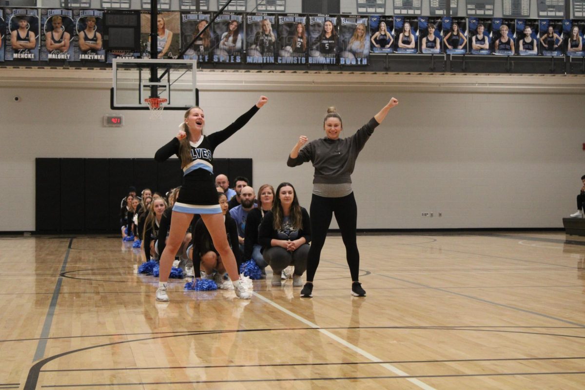PE teacher Annie Chadwick and freshman Abby Hagestad preform a cheer together. Each teacher and cheerleader duo choreographed an eight count to preform at the winter pep rally on Dec. 8th 2023.