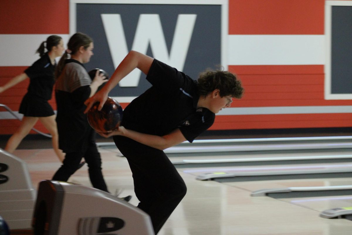Sophomore Zander Limbeck (18) swinging the ball back. Limbeck gets a strike in the second frame on December 5, 2023.