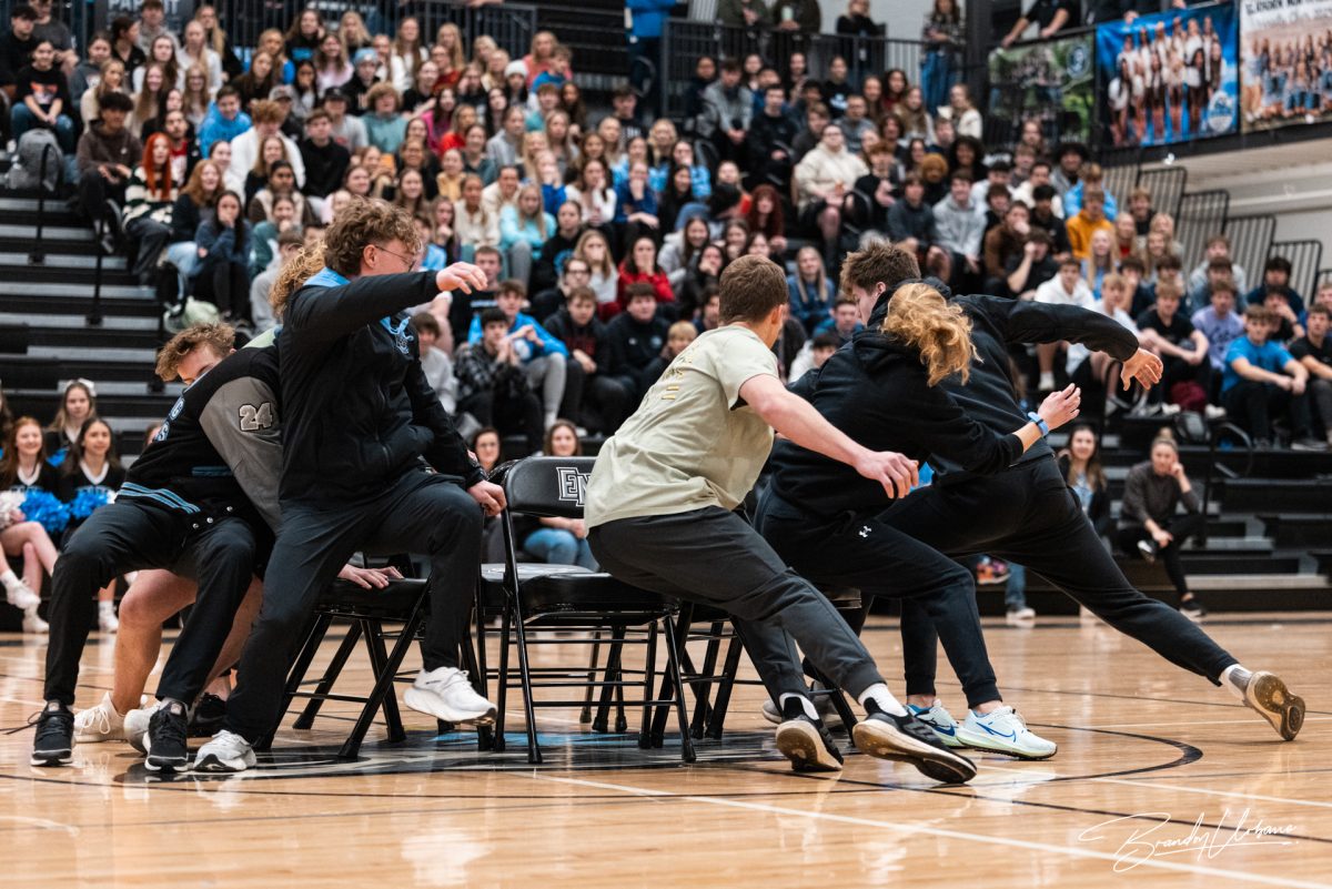 Winter sport athletes fight for the chairs left in a game of musical chairs. As the game continued, the game intensified at the winter pep rally Dec. 8th 2023. 