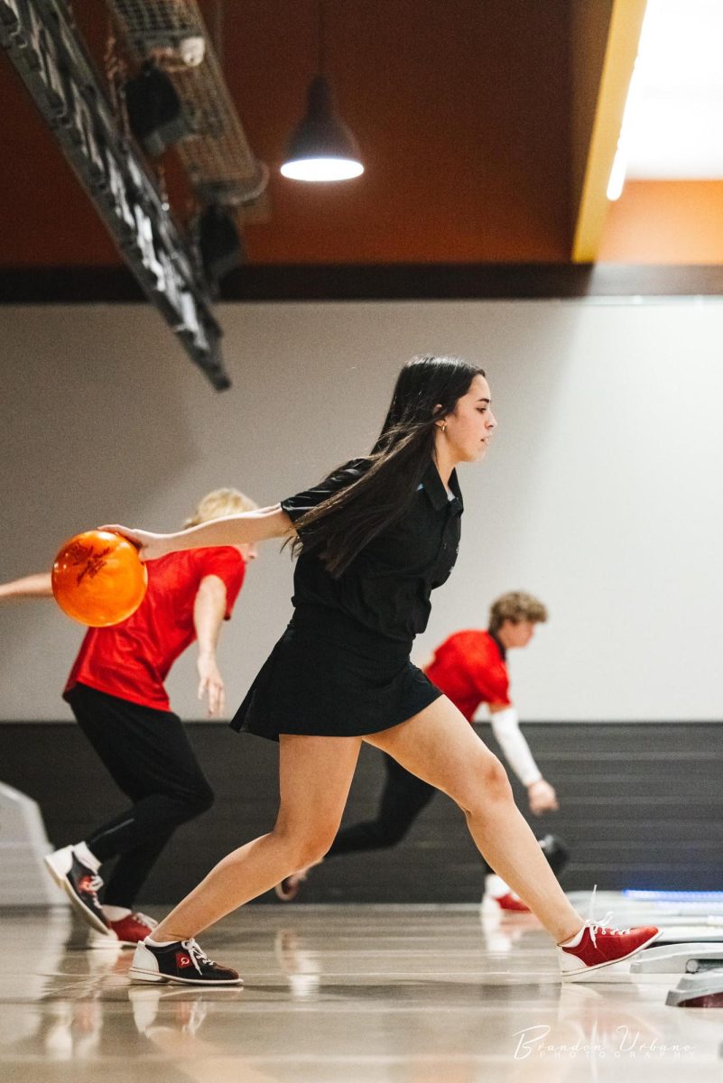 Senior Ellie Lary prepares to throw the ball. Lary was bowling at the Mark in a tournament. 